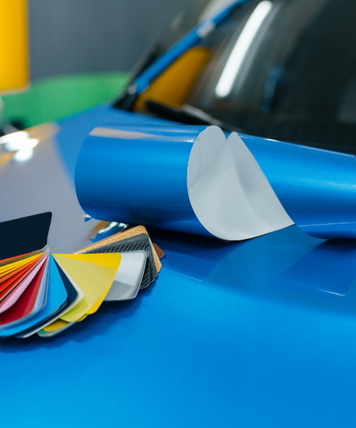 A close up of a blue car with a lot of different colors